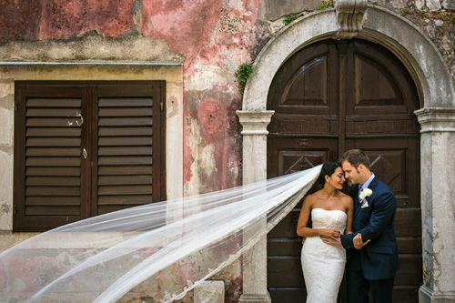 Bride and Groom during the couple session while the veil is flowing in the wind.
